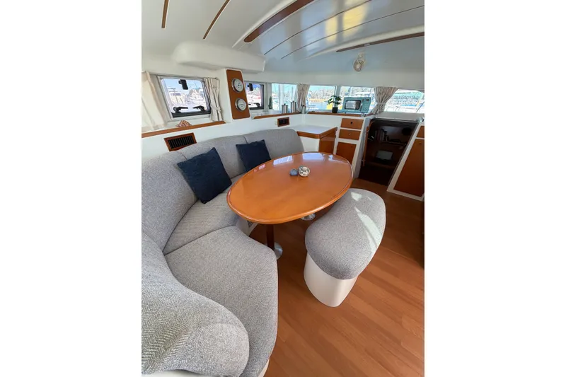 Slide: The Image of Interior of 2005 Lagoon 380 S2 catamaran with cozy seating and dining area. - 72