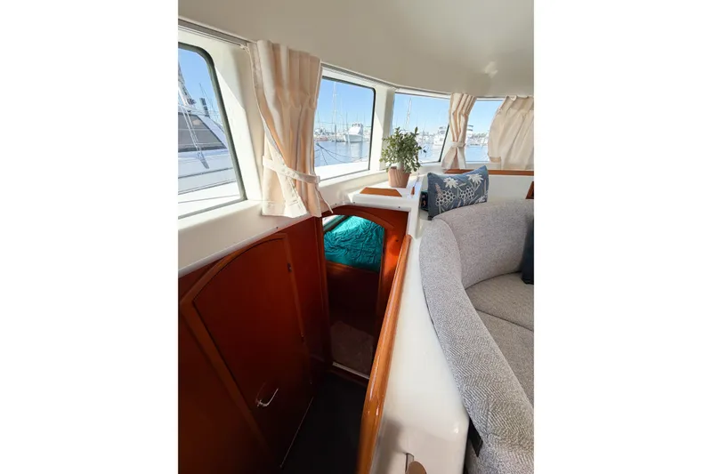 Slide: The Image of Interior of 2005 Lagoon 380 S2 catamaran with cozy seating and nautical decor. - 74