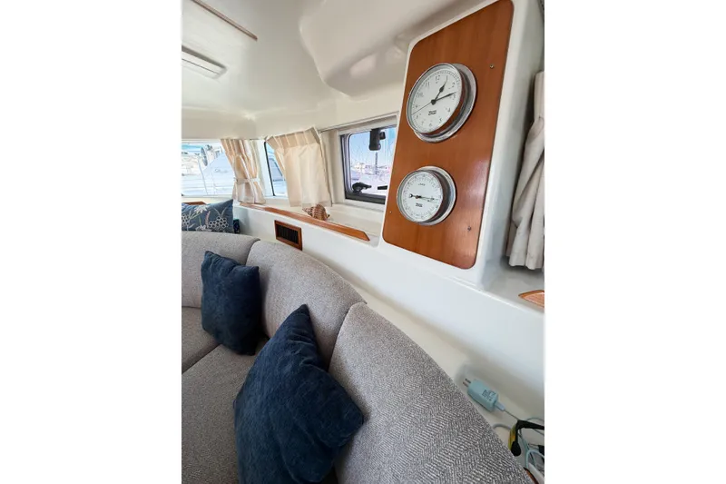 Slide: The Image of Interior of 2005 Lagoon 380 S2 yacht with cozy seating and nautical instruments. - 75