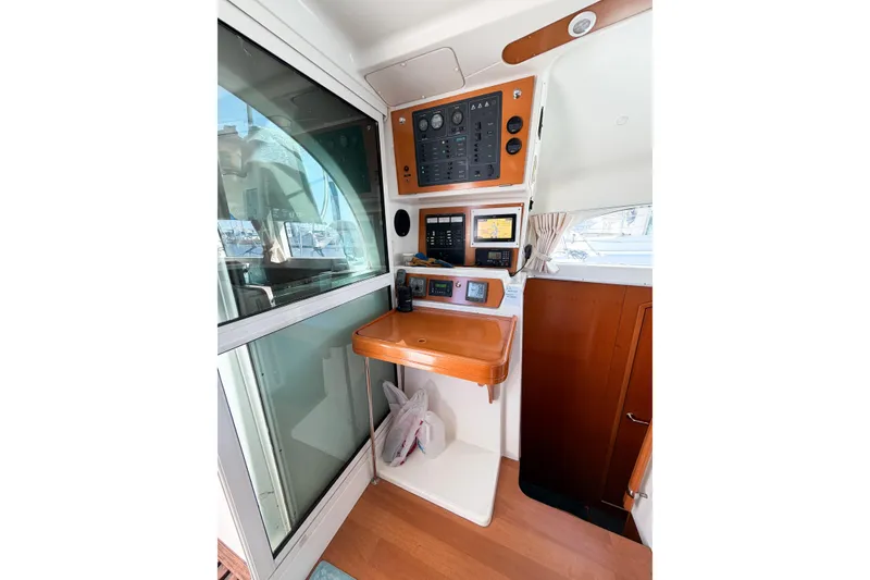 Slide: The Image of Control panel of a 2005 Lagoon 380 S2 catamaran with navigation equipment. - 76