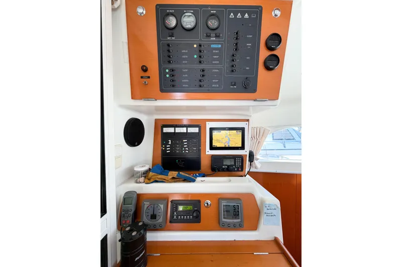 Slide: The Image of Control panel of a 2005 Lagoon 380 S2 catamaran with navigation equipment. - 77
