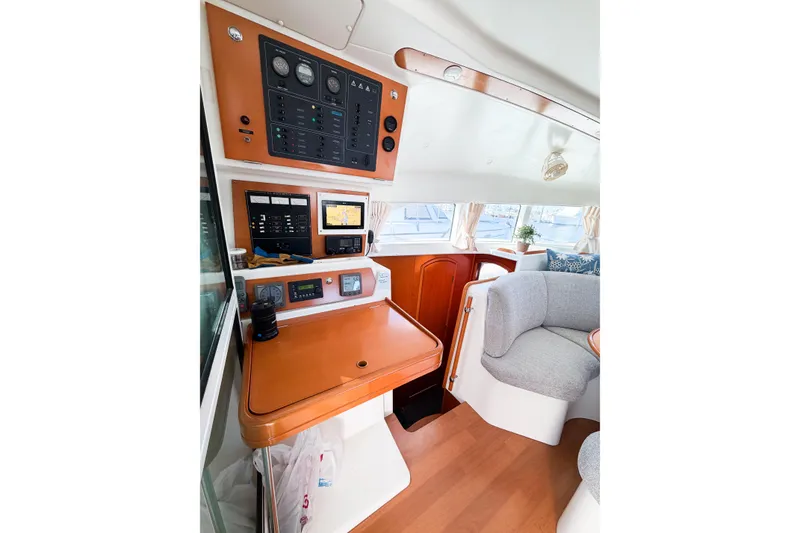 Slide: The Image of Interior of 2005 Lagoon 380 S2 yacht with navigation panel and seating area. - 79