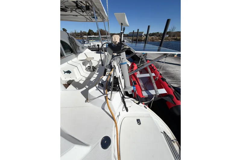 Slide: The Image of 2005 Lagoon 380 S2 catamaran deck with equipment and docked inflatable boat. - 8