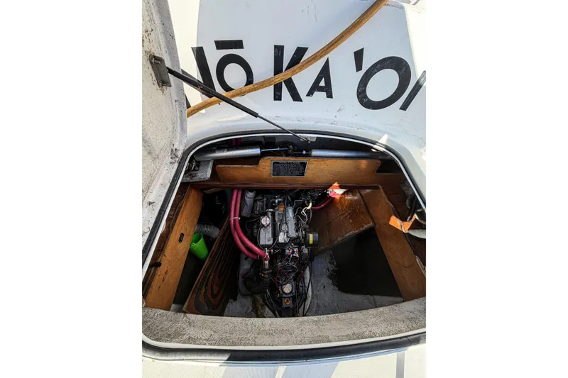 Slide: The Image of Engine compartment of a 2005 Lagoon 380 S2 catamaran, showing mechanical components and wiring. - 81