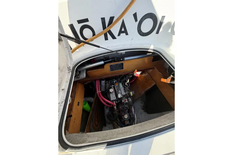 Slide: The Image of Engine compartment of a 2005 Lagoon 380 S2 catamaran with visible mechanical components. - 82