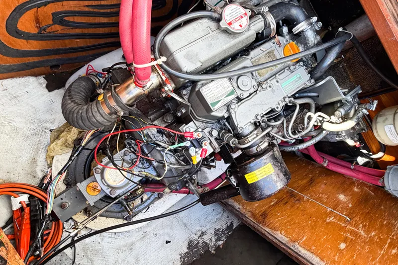 Slide: The Image of Engine compartment of a 2005 Lagoon 380 S2 sailboat with visible wiring and components. - 83
