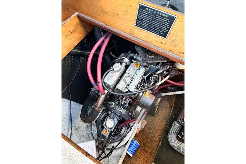 Slide: The Image of Engine compartment of a 2005 Lagoon 380 S2 catamaran with visible wiring and components. - 84