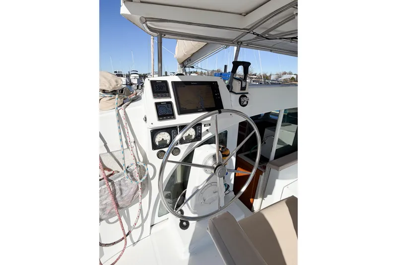 Slide: The Image of Steering wheel and navigation instruments on 2005 Lagoon 380 S2 catamaran. - 88