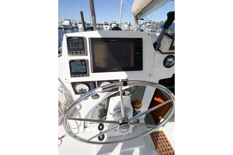 Slide: The Image of Steering wheel and navigation instruments on 2005 Lagoon 380 S2 catamaran. - 89