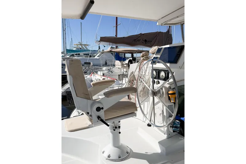 Slide: The Image of Helm station of 2005 Lagoon 380 S2 catamaran with steering wheel and captain's chair. - 90