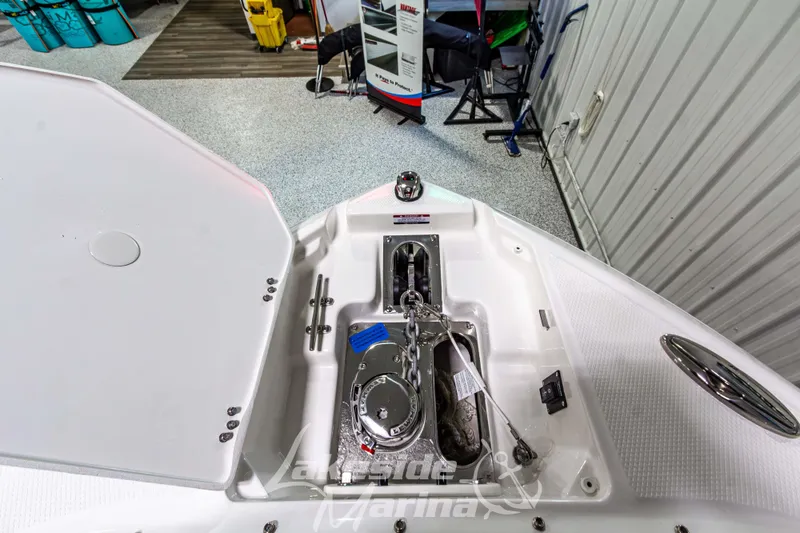 Slide: The Image of 2026 Chaparral SSX 6 boat anchor compartment with chain and winch in showroom. - 38