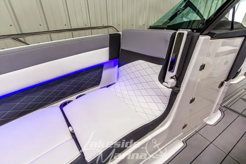 Slide: The Image of 2026 Chaparral SSX 6 boat interior with luxurious seating and ambient blue lighting. - 33