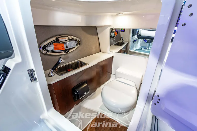 Slide: The Image of 2026 Chaparral SSX 6 boat interior with sink and toilet in compact bathroom. - 26