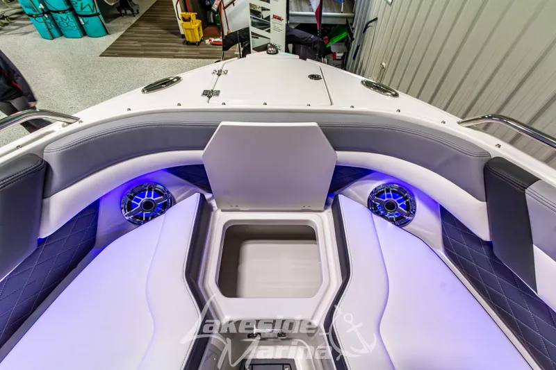 Slide: The Image of 2026 Chaparral SSX 6 boat interior with open storage, LED lighting, and premium seating. - 37