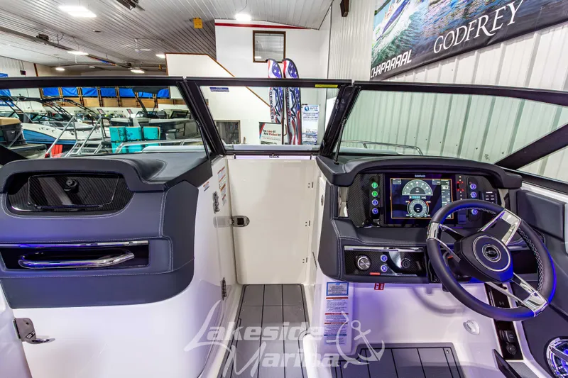 Slide: The Image of 2026 Chaparral SSX 6 boat interior with modern dashboard and steering wheel in showroom. - 27