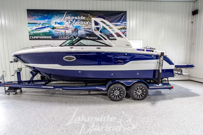 Slide: The Image of 2026 Chaparral SSX 6 boat on trailer in showroom, Lakeside Marina banner. - 3