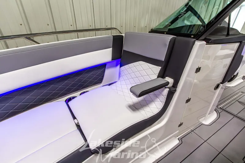 Slide: The Image of 2026 Chaparral SSX 6 boat interior with sleek seating and ambient blue lighting. - 34