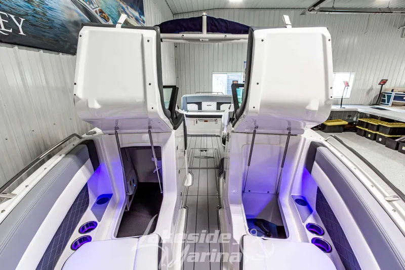 Slide: The Image of 2026 Chaparral SSX 6 boat interior with open storage compartments and blue accent lighting. - 35
