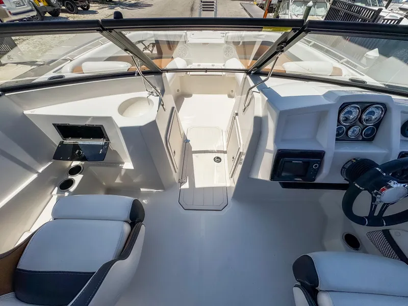 Slide: The Image of 2023 Starcraft SVX 190 OB boat interior with modern dashboard and seating. - 11