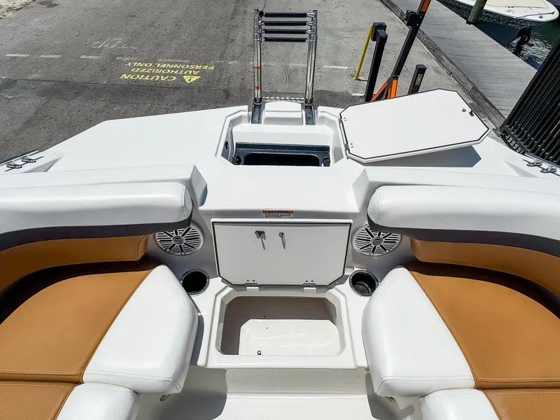 Slide: The Image of 2023 Starcraft SVX 190 OB boat interior with white and tan seating, storage, and speakers. - 14