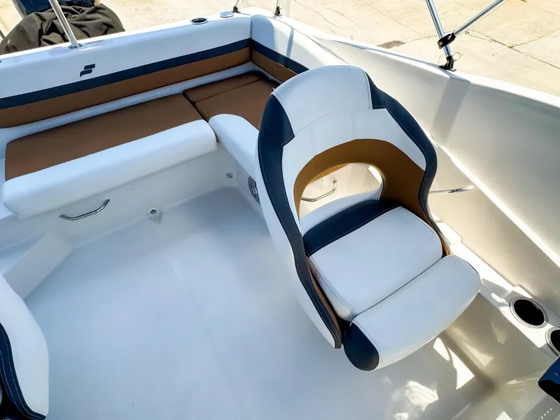 Slide: The Image of 2023 Starcraft SVX 190 OB boat interior with white and brown seating. - 6