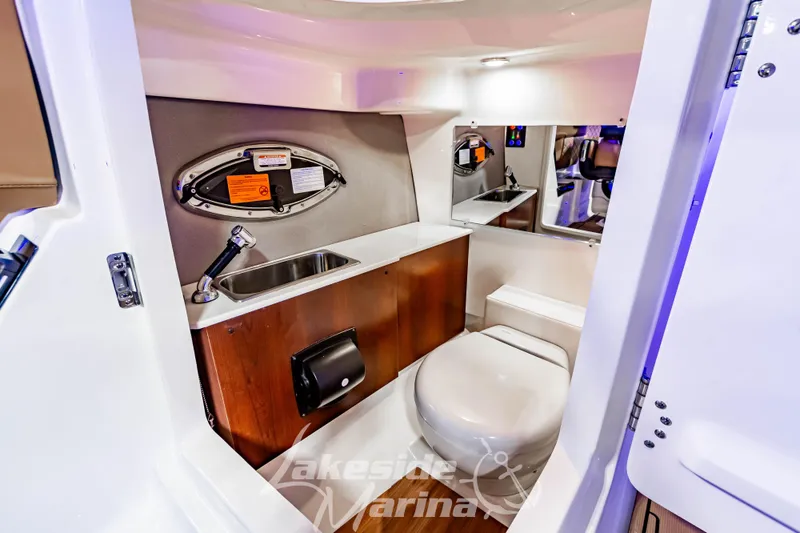 Slide: The Image of 2026 Chaparral SSX 6 boat interior bathroom with sink, toilet, and mirror. - 21