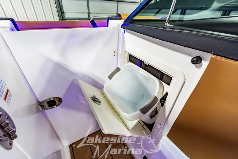 Slide: The Image of 2026 Chaparral SSX 6 boat interior with built-in cooler and storage compartment. - 26