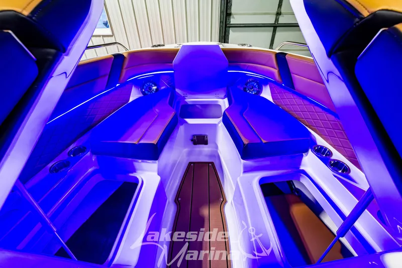 Slide: The Image of 2026 Chaparral SSX 6 boat interior with blue LED lighting and luxurious seating. - 30