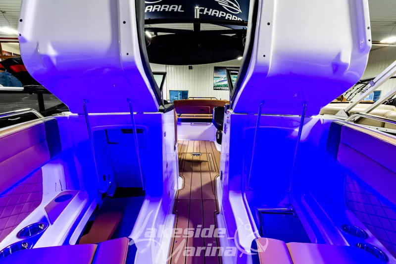 Slide: The Image of 2026 Chaparral SSX 6 boat interior with blue lighting and luxurious seating. - 31