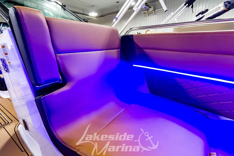 Slide: The Image of Luxurious seating with blue LED lighting in 2026 Chaparral SSX 6 boat interior. - 33