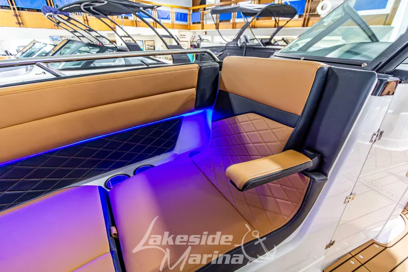 Slide: The Image of 2026 Chaparral SSX 6 boat interior with tan and black seating, blue LED lighting. - 39