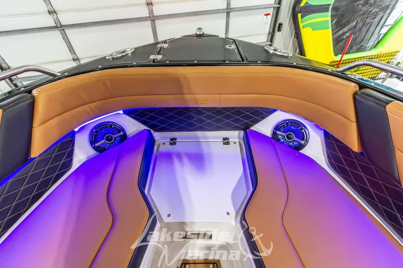 Slide: The Image of 2026 Chaparral SSX 6 boat interior with tan seating, blue LED lights, and speakers. - 41