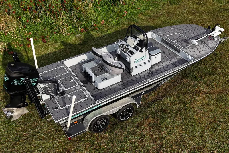 Slide: The Image of 2014 SCB Stingray Sport 25 boat on grass, featuring sleek design and modern equipment. - 20