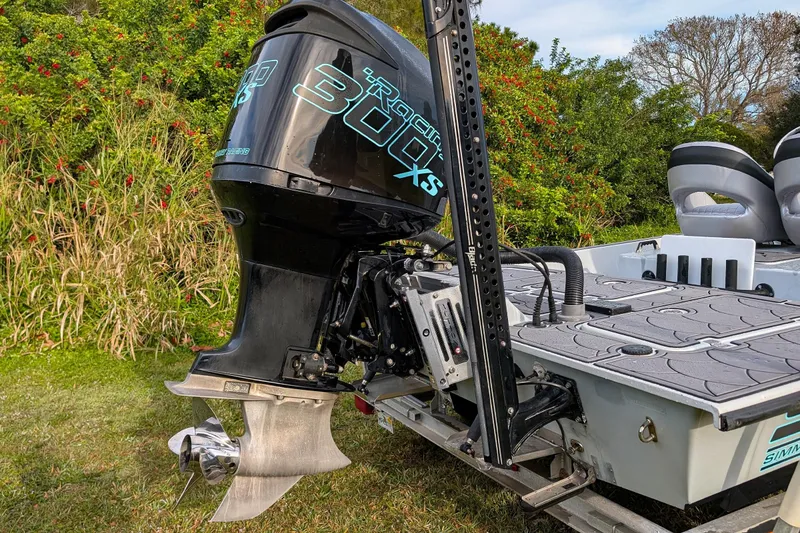 Slide: The Image of 2014 SCB Stingray Sport 25 boat with powerful 300XS engine, parked on grass. - 5