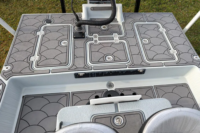 Slide: The Image of 2014 SCB Stingray Sport 25 boat deck with gray patterned flooring. - 6