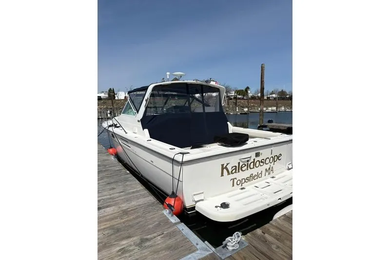 Slide: The Image of 2001 Tiara Yachts 3100 Open docked, rear view with "Kaleidoscope" name visible. - 1