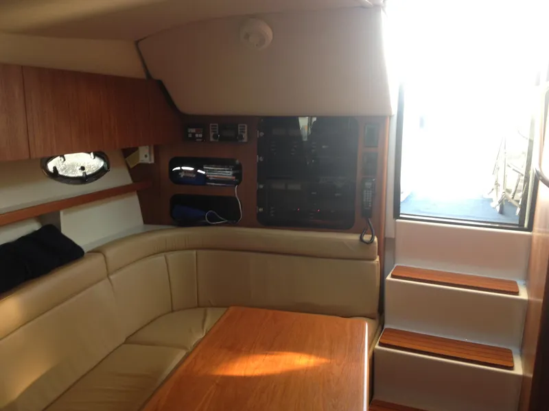 Slide: The Image of Interior of 2001 Tiara Yachts 3100 Open with seating area and stairs. - 10