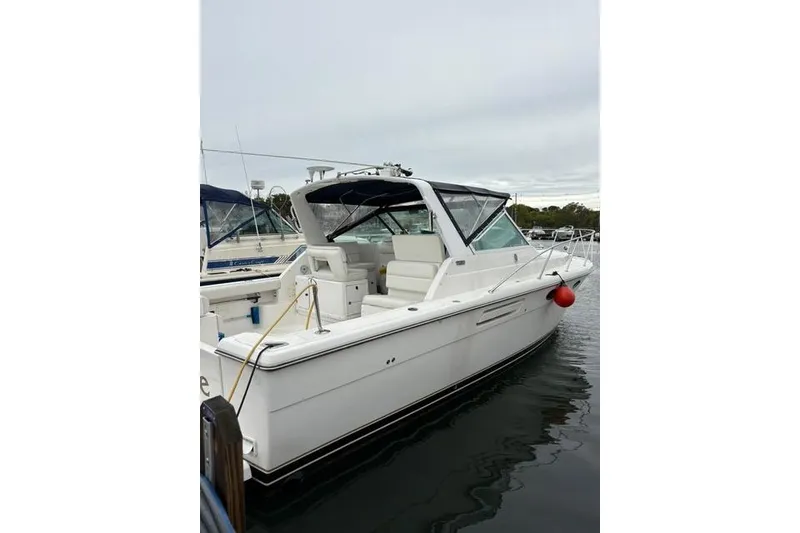 Slide: The Image of 2001 Tiara Yachts 3100 Open boat docked in a marina. - 2