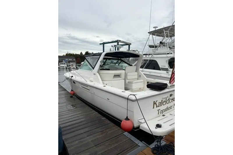 Slide: The Image of 2001 Tiara Yachts 3100 Open docked, featuring sleek design and spacious seating. - 5