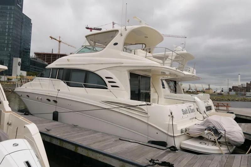 Slide: The Image of 2001 Sea Ray 540 Cockpit Motor Yacht docked at marina under cloudy sky. - 1