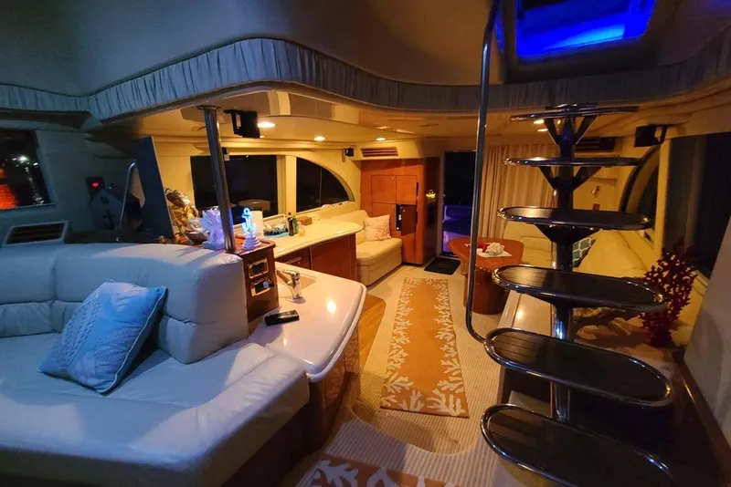 Slide: The Image of Luxurious interior of 2001 Sea Ray 540 Cockpit Motor Yacht with elegant seating and spiral staircase. - 15