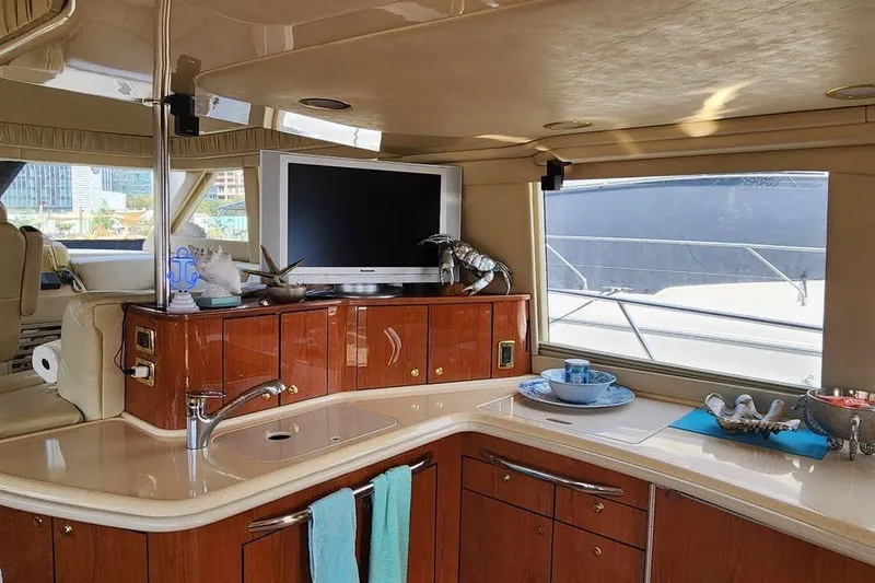 Slide: The Image of Luxurious interior of 2001 Sea Ray 540 Cockpit Motor Yacht with elegant wood cabinetry. - 17