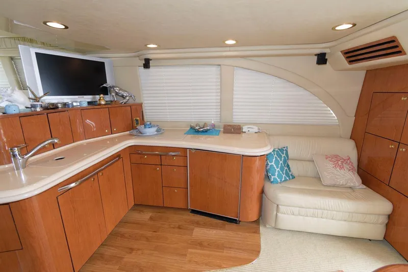 Slide: The Image of Luxurious interior of 2001 Sea Ray 540 Cockpit Motor Yacht with modern kitchen and seating area. - 18
