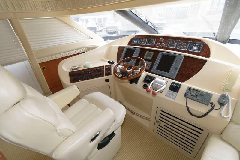 Slide: The Image of 2001 Sea Ray 540 Cockpit Motor Yacht helm with leather seat and advanced navigation controls. - 22