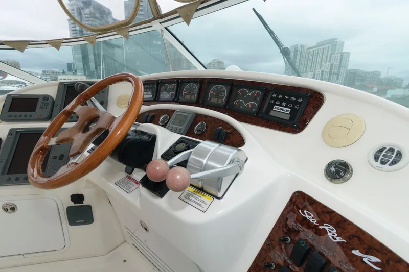 Slide: The Image of 2001 Sea Ray 540 Cockpit Motor Yacht helm with wood steering wheel and control panel. - 23