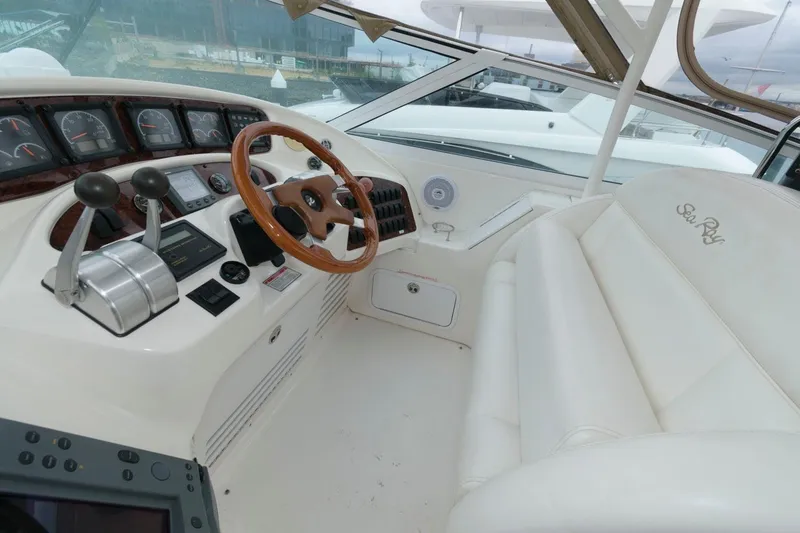 Slide: The Image of Interior of 2001 Sea Ray 540 Cockpit Motor Yacht with helm and seating area. - 25