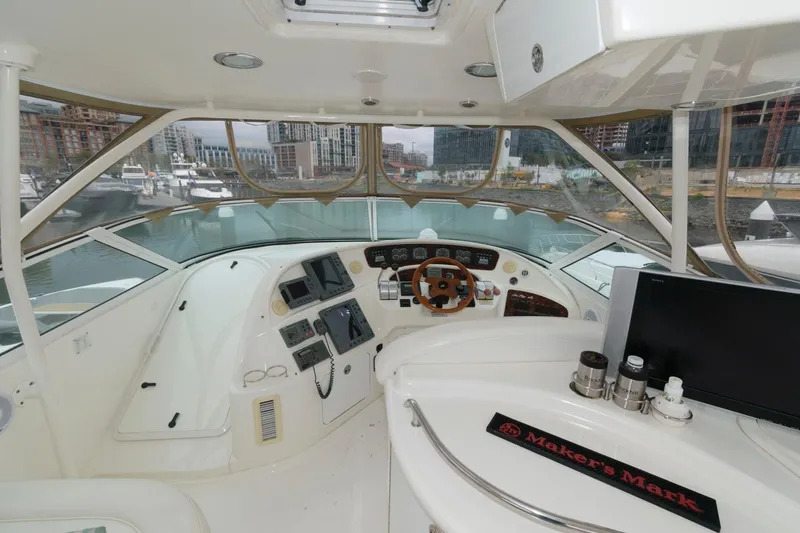 Slide: The Image of 2001 Sea Ray 540 Cockpit Motor Yacht helm with modern controls and city marina view. - 26