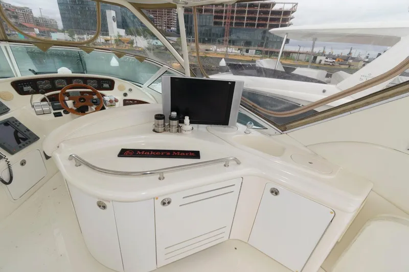 Slide: The Image of 2001 Sea Ray 540 Cockpit Motor Yacht helm with steering wheel, controls, and navigation equipment. - 27