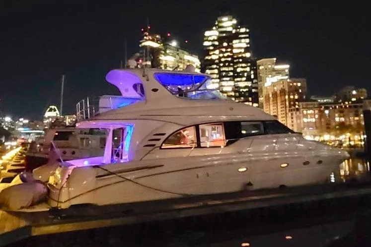 Slide: The Image of 2001 Sea Ray 540 Cockpit Motor Yacht docked at night with city lights. - 3