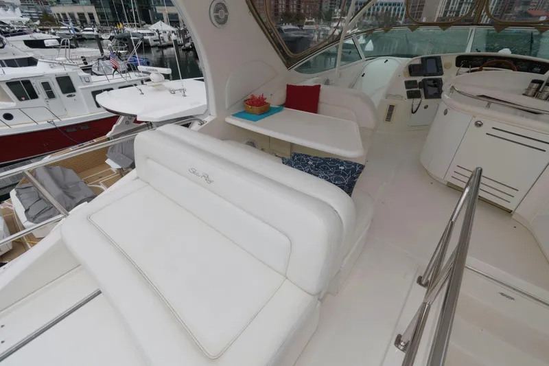 Slide: The Image of Luxurious 2001 Sea Ray 540 Cockpit Motor Yacht interior with white seating and marina view. - 30